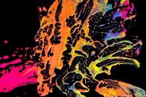 Multi-color paint drops and splotch on black background photo