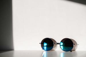 blue sunglasses on white background photo