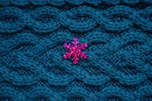 teal blue knit background sweater with pink snowflake photo