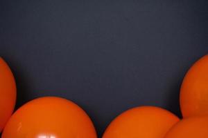 simple orange balloons on black background photo