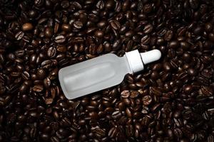 Face serum on coffee beans background photo