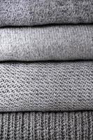 stack of grey knit sweaters photo