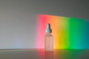 Face serum in front of rainbow photo