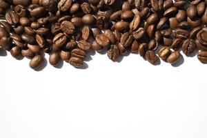 Isolated roasted coffee beans in harsh light photo