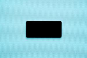 Horizontal blank phone on blue wave background photo
