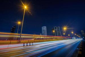 Long exposure shutter speed of car moving in road photo