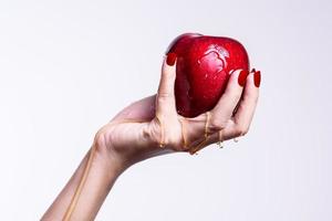 woman holding a red apple photo