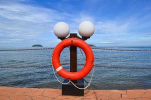 Lifeguard ring buoys with blue cloud sky view at the beach. Safety. photo