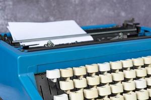 An old classic typewriter on wooden desk. Copy space. For text purpose. photo