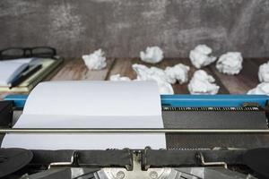 An old classic typewriter with trash paper background. Copy space. photo