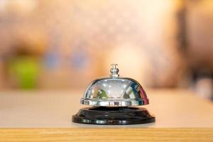 Restaurant or hotel bell of services calling on wooden counter photo