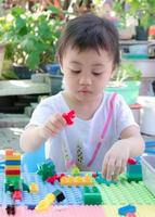 Preschooler child playing creative colorful building blocks toy at home. photo