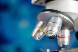 Close up shot of microscope lens and colorful blur blue background copy space photo