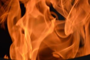 Bright orange flame. Abstract fire texture. Flaming background. Combustion. Warm. photo
