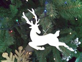 Reindeer on the Christmas tree, decorative decoration of Santa's helper. Festive background. photo