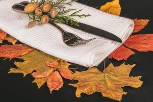 Fork and knife with autumn leaves and acorns photo