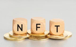 NFT concept. Coins and wooden blocks with text. Copy space photo
