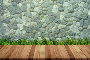 Empty wood table with stone wall texture background. For display or montage your products. photo