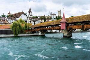 Close up a famous Chapel Bridge with the city of Lucern in the background