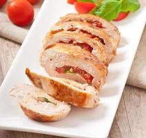 Grilled chicken breast stuffed with basil, tomato and garlic photo