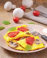 Delicious omelet with tomatoes and mushrooms for breakfast photo