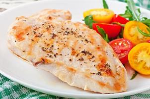 Grilled chicken breasts and vegetables photo