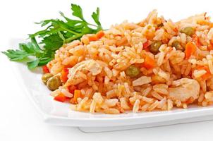 Pilaf with chicken, carrot and green peas photo