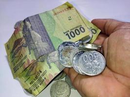 Banknotes and coins in hand photo