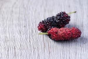 fresh mulberries on wooden background photo