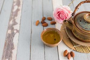 tea set and almon nut on old wood background photo