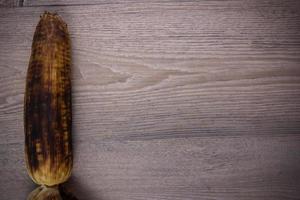 grill corn on wood background photo