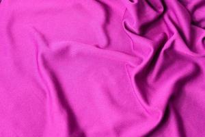 Pink fabric textured background. Sports pink clothing fabric jersey textured. photo