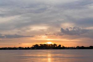 Colorful sky at sunset. Landscape sky at twilight time. Mirror sunset reflection on the water at Meakhong national river,Thailand. photo