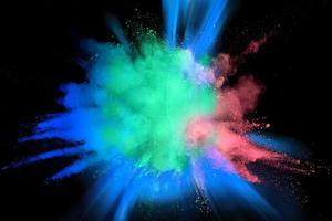 Multicolored powder explosion on black background. photo