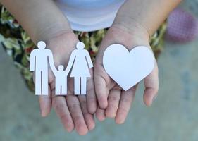 Children hands holding small model of heart and family , concept family photo