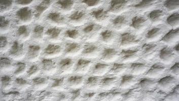 textura de burbuja en el acabado de la pared de cemento blanco foto