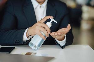 Business man washing hands with alcohol gel or antibacterial soap sanitizer after using a public restroom.Hygiene concept. prevent the spread of germs and bacteria and avoid infections corona virus photo
