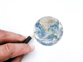 Hands are drawing the earth representing conservation.  Elements of this image furnished by NASA. photo