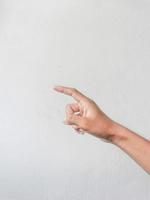 Close-up of hands showing gestures on textured background. photo