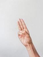 Close-up of hands showing gestures on textured background. photo