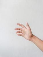 Close-up of hands showing gestures on textured background. photo