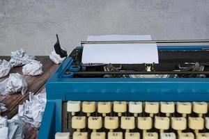 An old classic typewriter with trash paper background. Copy space. photo