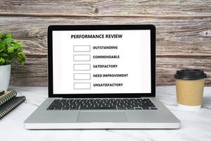 Performance review checklist text on white screen laptop or notebook. photo