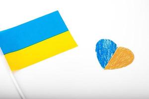 Flag of Ukraine on a white background and paper heart, painted in the color of the flag of Ukraine. The symbol of state photo