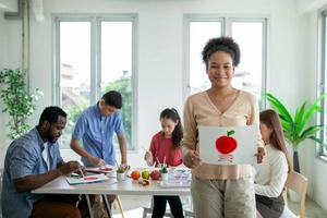 children painting with watercolors in classroom photo