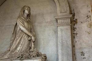 Statue on an old tomb - beginning of 1800, marble - located in Genoa cemetery, Italy photo