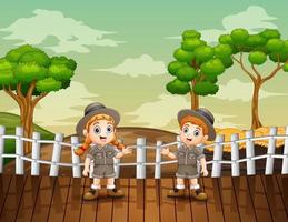 Cartoon illustration of zookeeper boy and girl in the open zoo vector