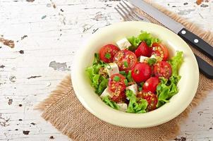 ensalada de tomate con lechuga, queso y mostaza y aderezo de ajo foto