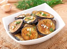 Platter of grilled eggplant with garlic and dill photo