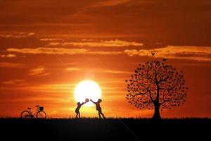 Two children are throwing balls in the meadow happily. Children's happiness concept photo